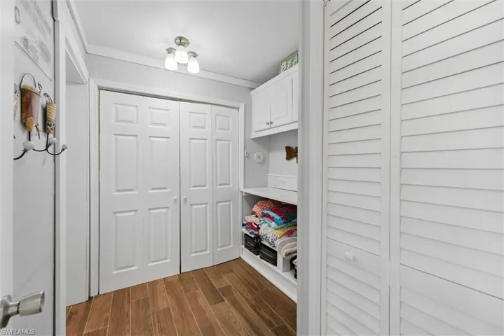 Mudroom with dark wood finished floors