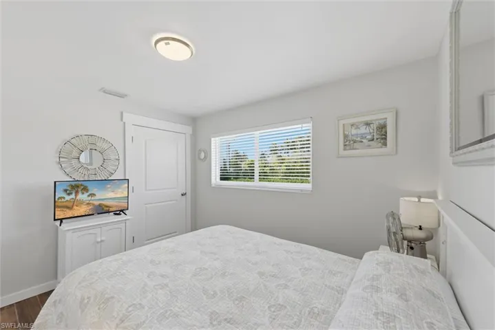 Bedroom featuring wood finished floors and baseboards