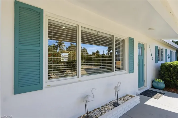 Entrance to property featuring stucco siding