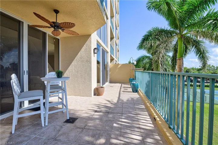 Expansive private balcony featuring tile flooring and a decorative ceiling fan
