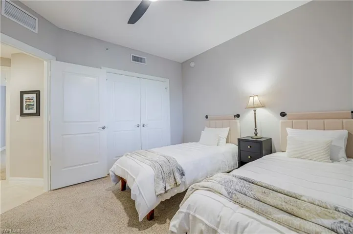 Bedroom featuring neutral wall colors, light-toned carpet flooring, a ceiling fan, and recessed lighting