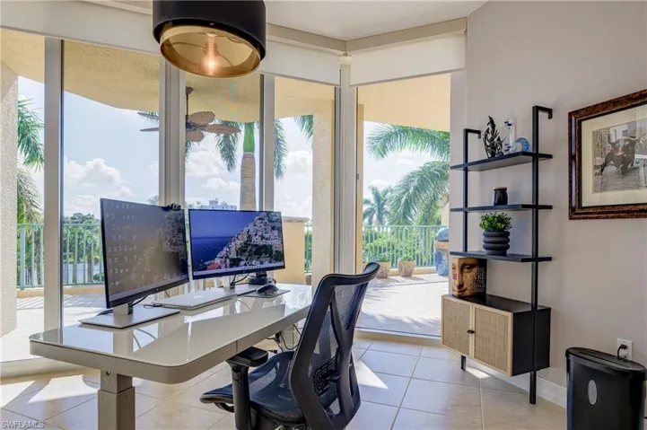 Bright interior space featuring a full wall of glass doors opening to an exterior balcony
