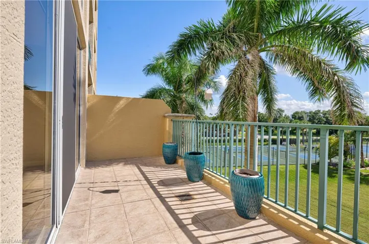 Private outdoor balcony featuring tile flooring and a sturdy metal railing