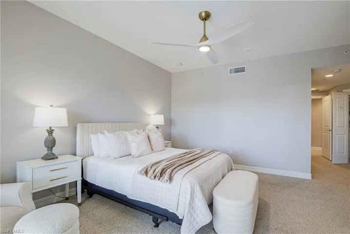 Bedroom featuring a vaulted ceiling with a modern ceiling fan, recessed lighting, and light-toned carpeting