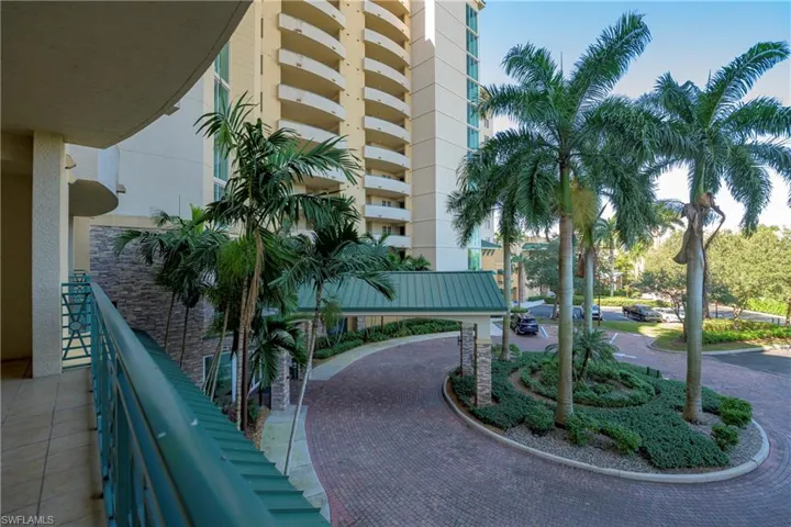 Curved exterior balcony featuring metal railings and tile flooring
