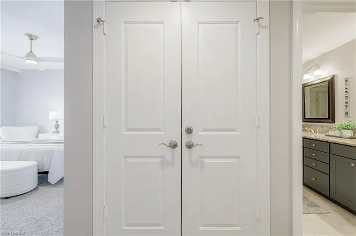 Dual paneled white doors with brushed nickel hardware
