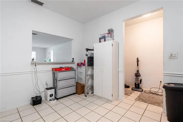 Kitchen with light tile patterned floors and baseboards