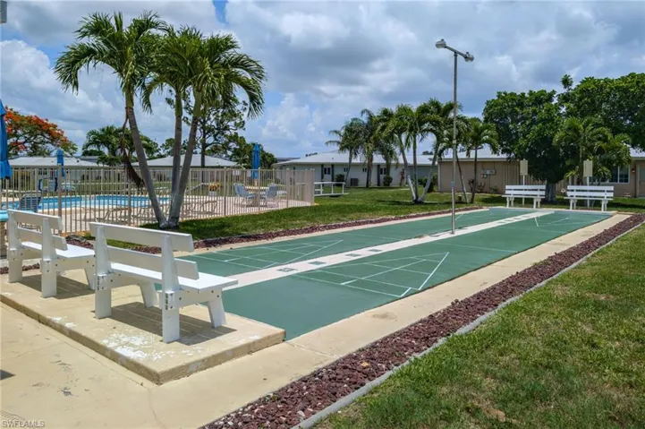 View of home's community with shuffleboard and a pool