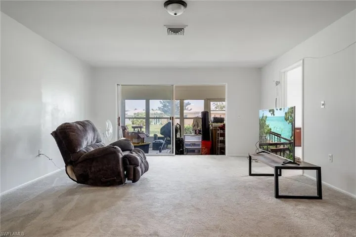 Sitting room with carpet floors and baseboards