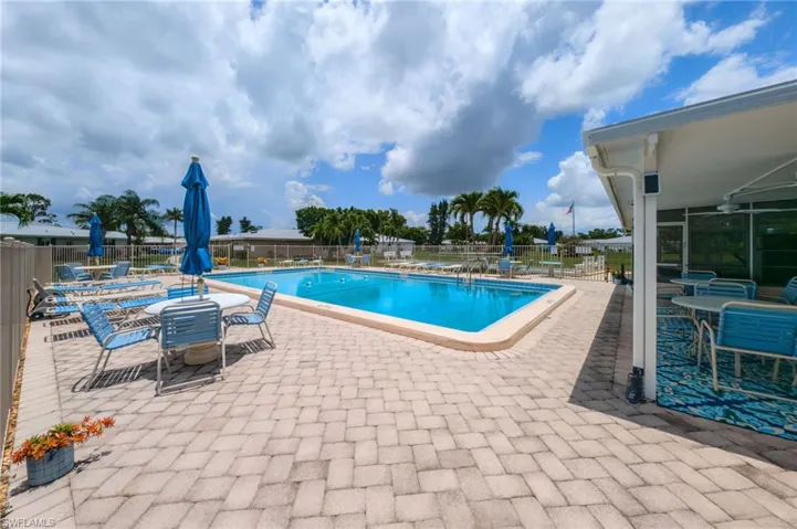 Community pool with a patio and a ceiling fan