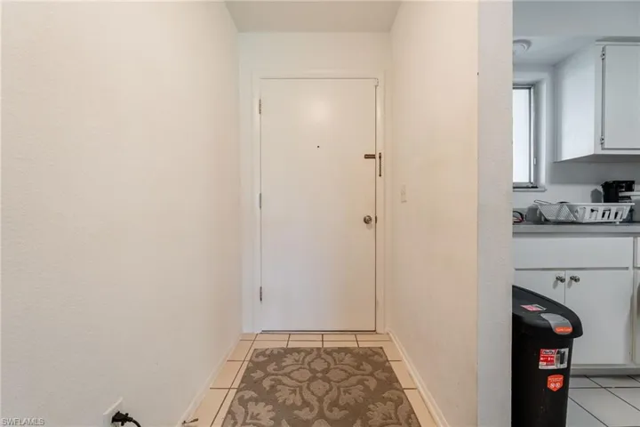 Doorway to outside featuring tile patterned floors
