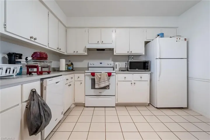 Kitchen with white appliances and white cabinetry