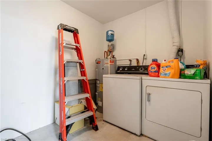 Washroom with electric water heater and washer and dryer