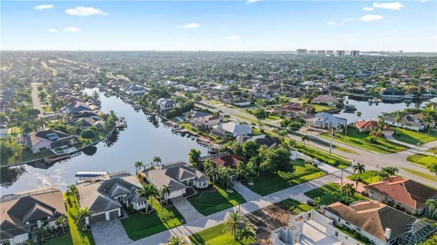 Waterfront community with extensive canal access, mature landscaping, and residential architecture