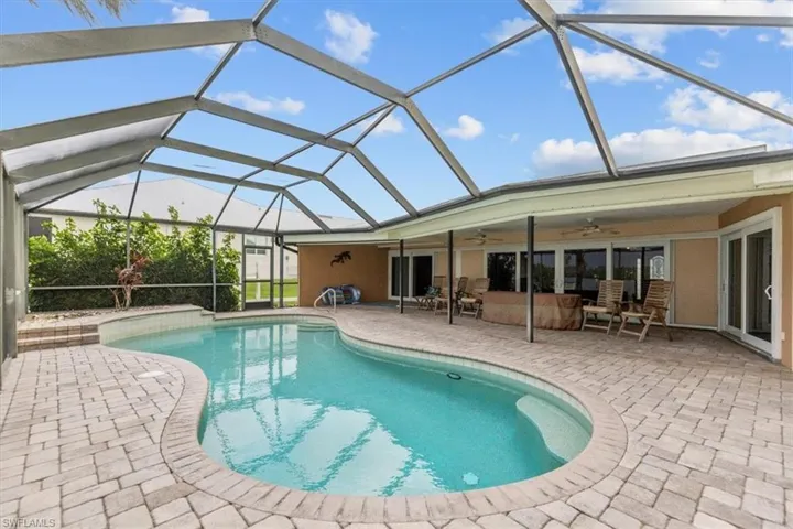 View of swimming pool featuring: an outdoor living space, a lanai, and a patio