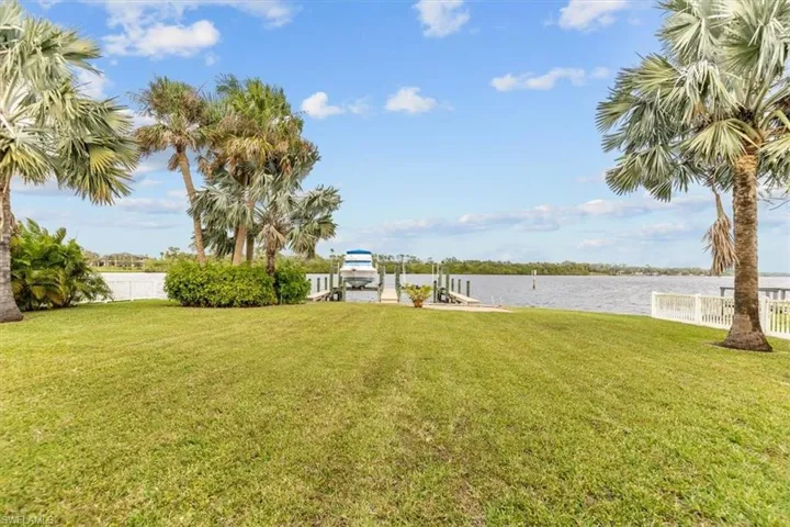 View of yard featuring a water view and a boat dock