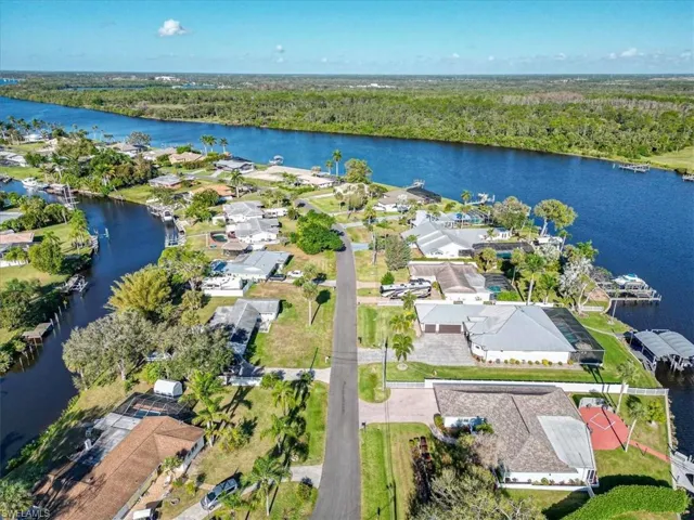 Birds eye view of property with a water view