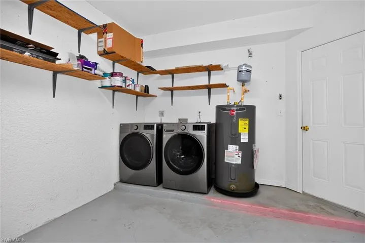 Utility area with a painted concrete floor, built-in shelving, and a water heater