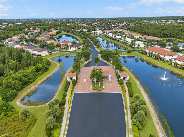 Gated community entrance with palm-lined median