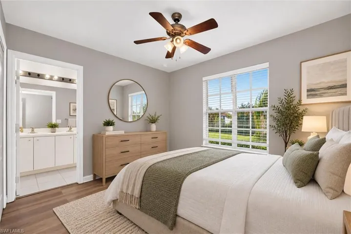 Room featuring wood-finish flooring, a ceiling fan, and a window with horizontal blinds