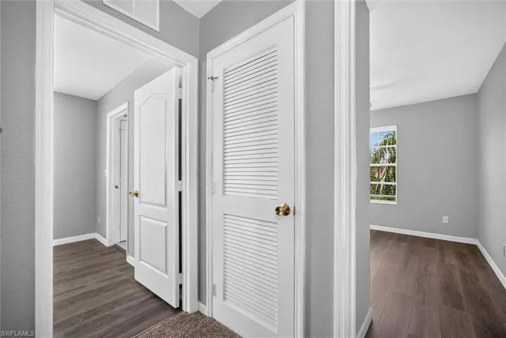 Wood-finish flooring throughout, white interior doors, louvered closet doors, and light-toned wall finishes