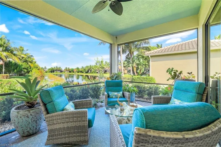 Relax and Unwind with a Stunning Lake View -Step into your private screened lanai, where serene lake views and lush tropical landscaping create the perfect backdrop for your morning coffee or evening glass of wine. The inviting outdoor seating area provides a tranquil space for entertaining or simply soaking in the beauty of Southwest Florida living. With vibrant greenery, colorful blooms, and a peaceful water view, this space offers the ultimate balance of relaxation and style.
