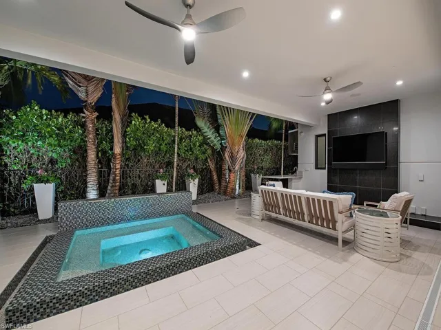 View of pool featuring an in ground hot tub, a patio, an outdoor living space, and ceiling fan