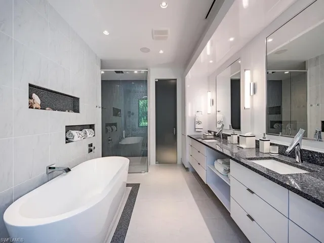 Bathroom with separate shower and tub, tile walls, tile floors, large vanity, and double sink