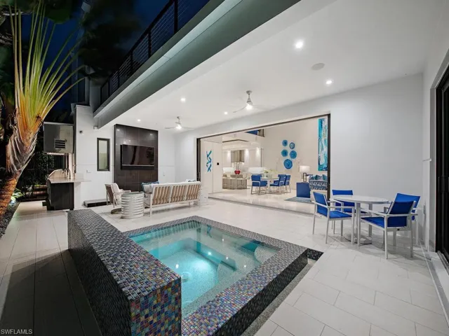 View of swimming pool with ceiling fan