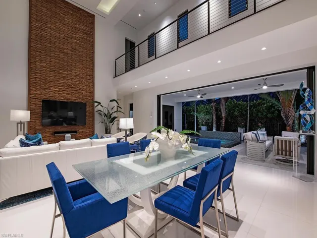 Tiled dining area featuring a high ceiling and ceiling fan