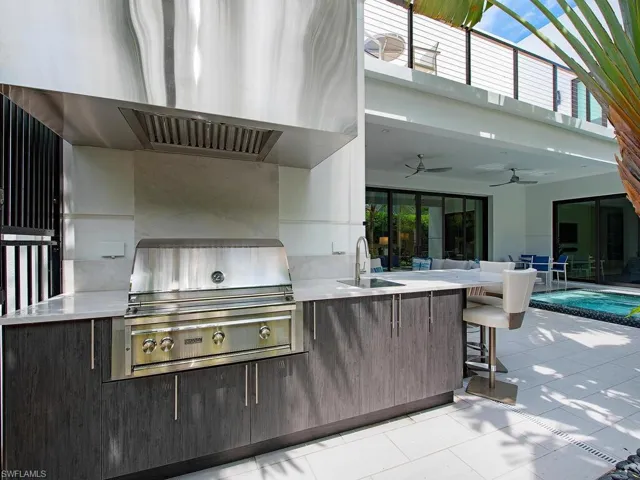 View of patio with sink, ceiling fan, an outdoor kitchen, and grilling area
