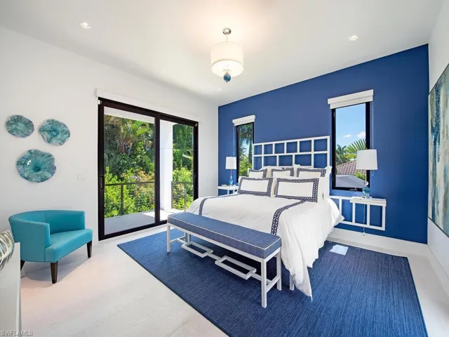 Bedroom with hardwood / wood-style floors and access to outside
