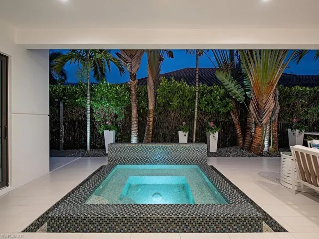 View of pool with an in ground hot tub
