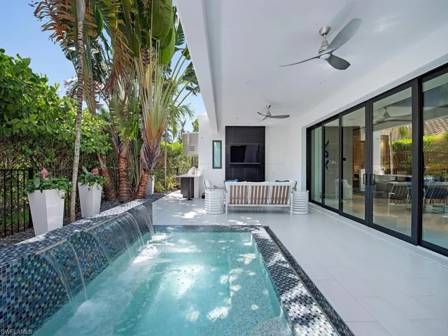 View of swimming pool featuring a patio, pool water feature, and ceiling fan