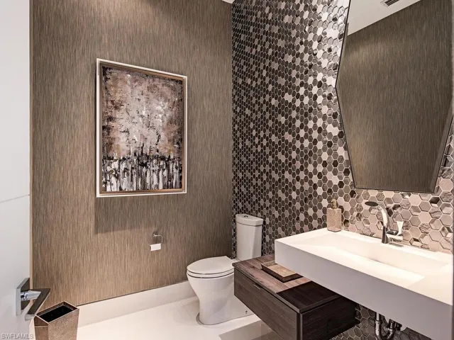 Bathroom featuring sink, tile flooring, and toilet