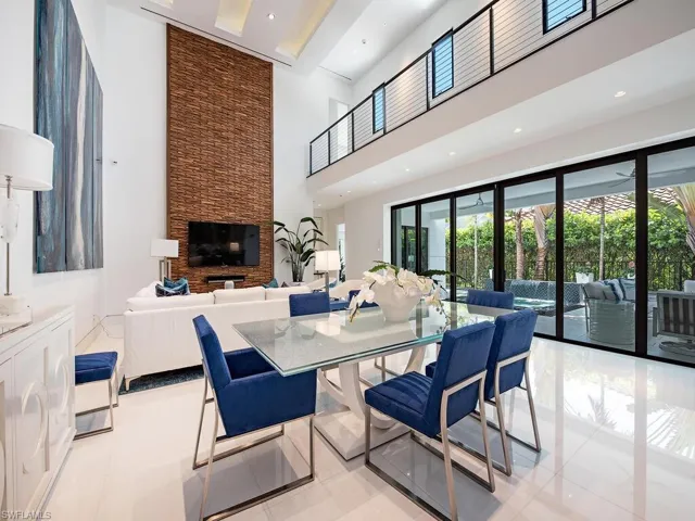 Dining area featuring a healthy amount of sunlight, light tile flooring, and a fireplace