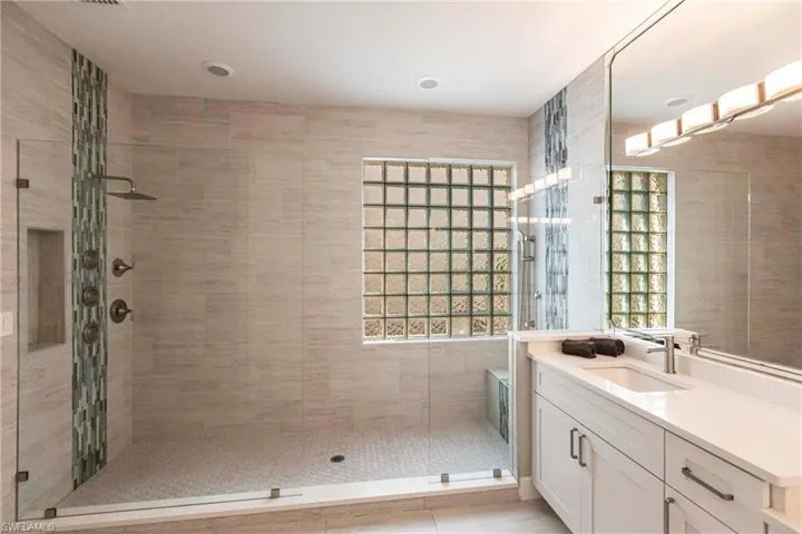 Full bathroom with a shower stall and vanity