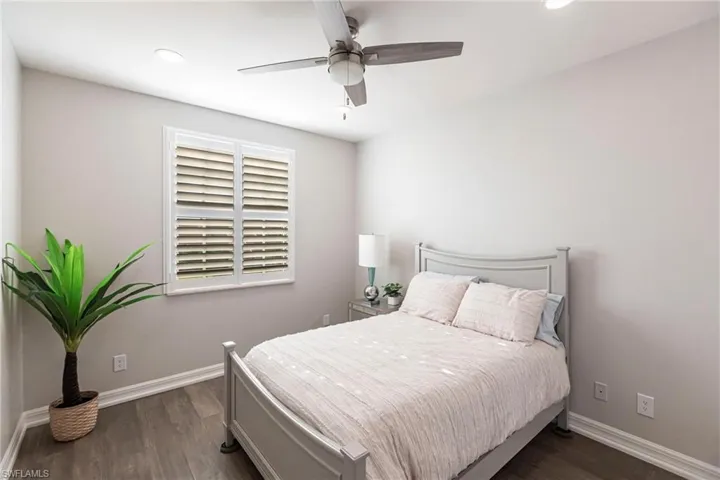 Bedroom featuring dark wood-style flooring, recessed lighting, and ceiling fan