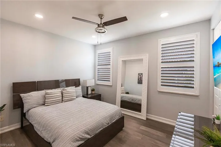 Bedroom with wood finished floors, recessed lighting, and a ceiling fan