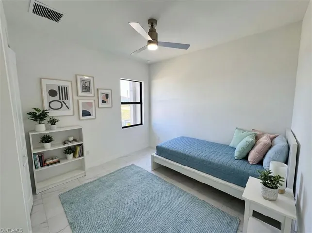 Bedroom with ceiling fan and light marble finish flooring