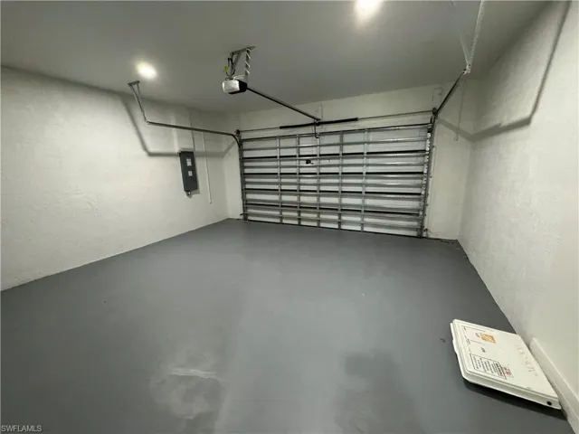 Garage featuring a textured wall and electric panel