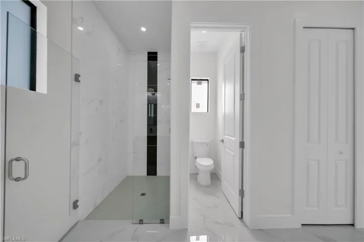 Full bath featuring marble finish floors, a marble finish shower, a closet, and recessed lighting