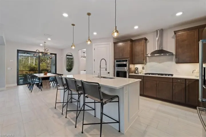 Living room with baseboards, recessed lighting, visible vents, and a notable chandelier