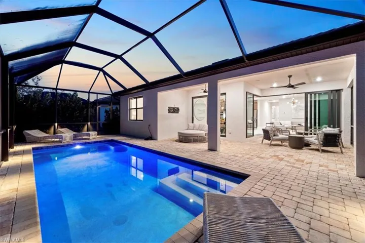 Ranch-style house featuring a garage, stucco siding, decorative driveway, and a front yard