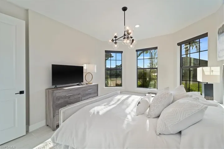 Bedroom featuring baseboards, a notable chandelier, visible vents, and recessed lighting