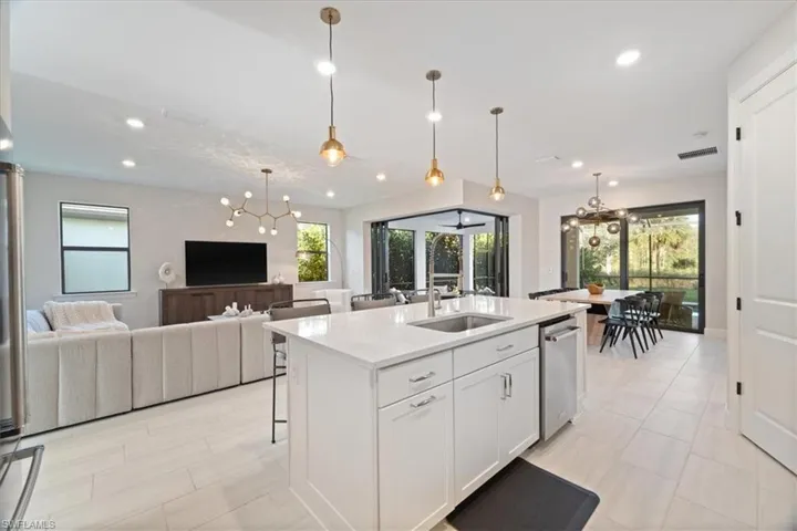 Living area featuring light wood-style flooring, visible vents, and recessed lighting