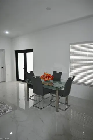 Dining area featuring light marble finish flooring and recessed lighting