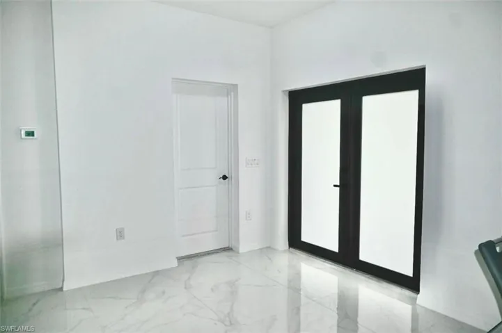 Spare room with light marble finish floors and baseboards