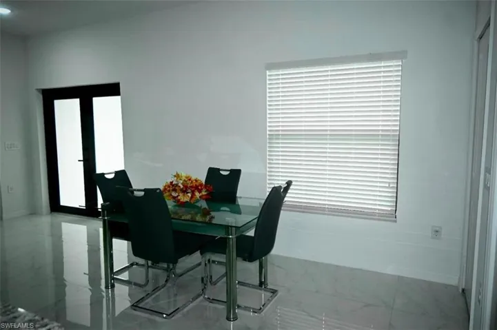 Dining room with light marble finish floors and baseboards