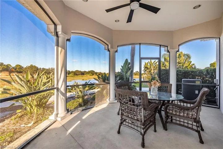 Sunroom with unfinished concrete flooring and a water view